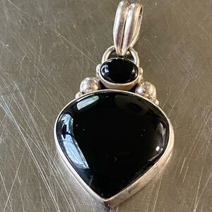 sterling silver pendant featuring a polished black onyx stone